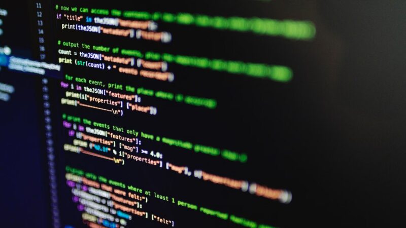 Close-up of software code on a dark screen with shallow depth of field